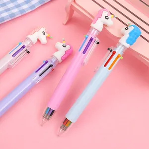 Macro detail of multi-color unicorn ballpoint pens with decorative cartoon toppers