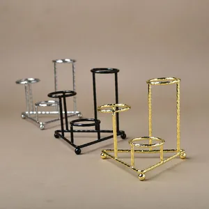 Three-tier metal crystal ball stand in gold, silver, and black with spiral texture