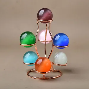 Rose gold multi-sphere metal stand with seven colorful cat eye crystal balls for home decor
