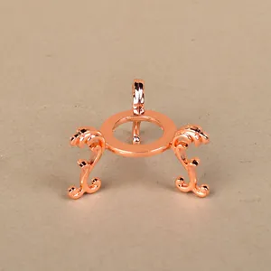 Macro detail of rose gold tripod display stand with vintage style scrolled metal patterns