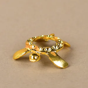 Detailed view of a golden turtle-shaped metal stand for crystal balls and decor