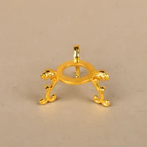 Detailed view of golden zinc alloy metal stand with vintage scrolls for crystal balls