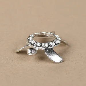 Detailed view of silver turtle stand with sparkling rhinestones and hollow metal ring