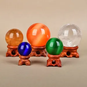 Five colored crystal balls with traditional rosewood carved stands in various sizes