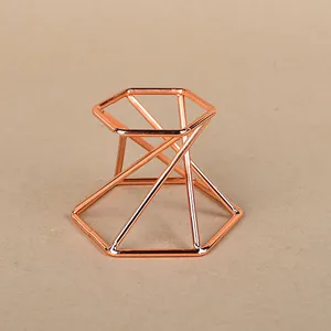 Macro shot of geometric rose gold metal stand with hexagon frame for crystal ball storage