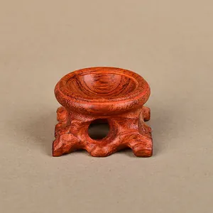 Detailed view of the rosewood crystal ball stand with elegant hollow carved design