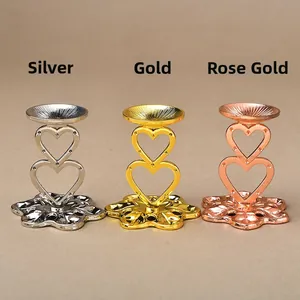 Detailed view of silver, gold and rose gold heart-shaped metal stands with electroplated finish