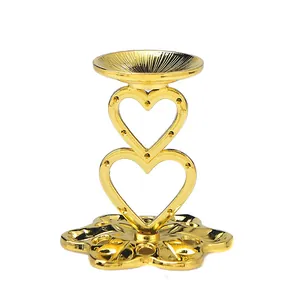 Golden heart-shaped metal stand for crystal ball ornaments with a floral base