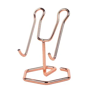 Polished rose gold metal display stand with hexagonal base and dual support hooks