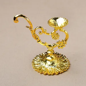 Detailed relief patterns on vintage gold metal candle holder with round base