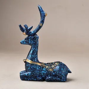 Deep blue starry deer figurine with gold floral relief and antlers for home decor