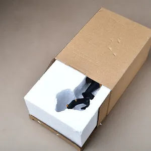 Protective packaging view showing elk ornament nested in foam padding and cardboard box