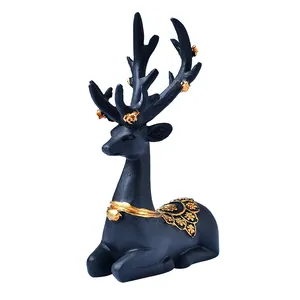 Elegant matte black deer ornament with golden floral antlers and intricate back carvings