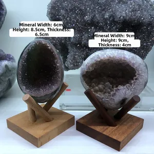 Detailed comparison of natural amethyst geodes on solid wood display stands with dimensions