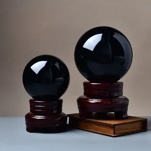 Polished obsidian crystal balls with wooden stands for desktop feng shui decoration