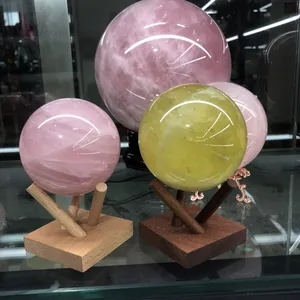 Detail showing natural rose quartz and citrine crystal spheres on solid wood stands