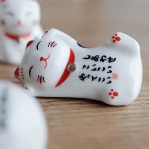 Japanese ceramic Maneki Neko lucky cat figurine for desk decor and chopstick rest
