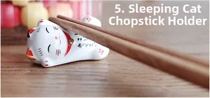 Ceramic lucky cat chopstick rest with sleeping beckoning cat design on a wooden table