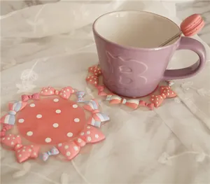 Pink and blue macaron style PVC coasters with 3D bows and polka dots for home decor