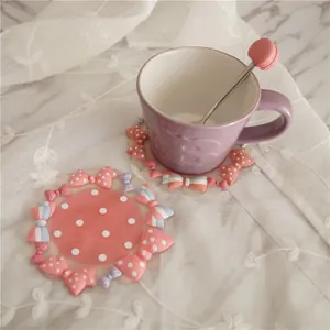Pastel pink bow and polka dot PVC coaster with a purple coffee cup on lace