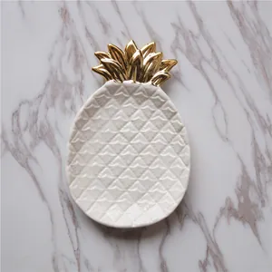 Minimalist white ceramic pineapple jewelry tray with golden leaf and diamond texture