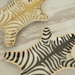 European zebra pattern ceramic jewelry tray with elegant gold trim and polished finish