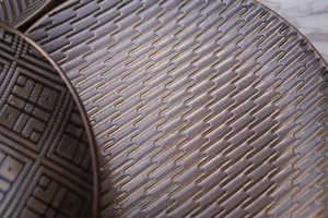 Artistic caramel gold ceramic dinner plate with embossed geometric texture patterns