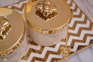 Ceramic jewelry storage jars with golden bee lids and honeycomb texture on tray