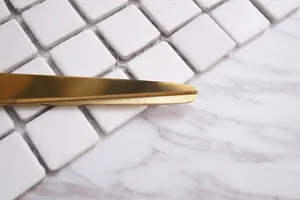 Nordic minimalist gold stainless steel scissors on marble surface with tile background
