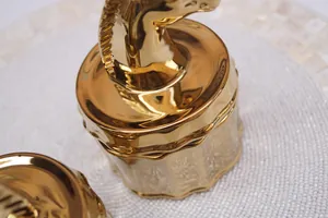 Golden unicorn ceramic jewelry box lid with polished metallic finish and detailed mane