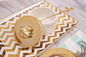 Detail of white ceramic honeycomb storage jar with golden bear lid and gold spoon