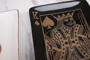 Luxury King of Spades jewelry tray with gold trim on black porcelain surface