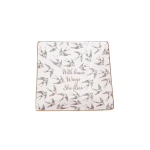 Square ceramic jewelry tray with gold rim and With Brave Wings She Flies bird pattern