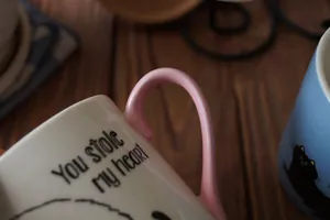 Close-up of ceramic cat mug with pink handle and You Stole My Heart text