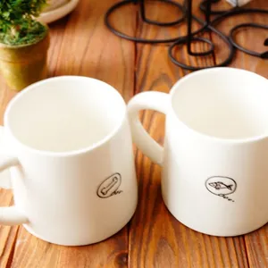 Tazas minimalistas de cerámica blanca con diseño de cola de gato y perro en madera