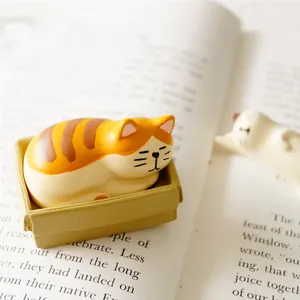 Sleeping tabby cat resin figurine desk decor set resting on an open book