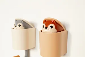 Close-up of squirrel gravity wall hooks showing pop-up mechanism and color options