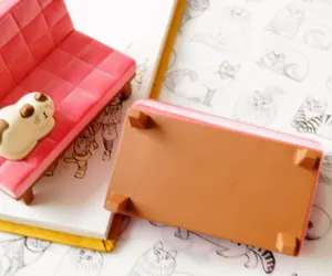 Pink velvet cat sofa phone stand with calico kitten figurine for desk decoration