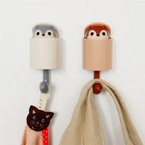 Creative squirrel pop-up wall hook in gray and brown, shown with hanging items