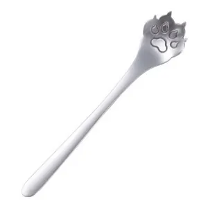 Macro detail of a creative stainless steel coffee spoon with a 3D cat paw handle design