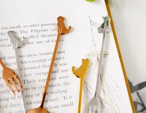 Detailed view of cat-shaped dessert spoons and forks in gold, silver, and rose gold finish