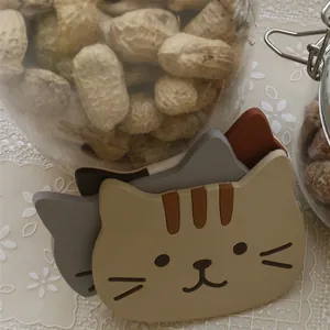 Cartoon calico cat silicone coasters set with heat-resistant non-slip design on lace