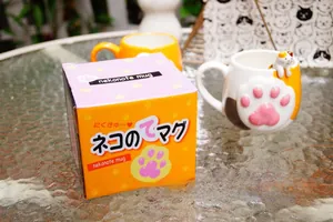 Ceramic cat paw mug with pink 3D paw relief and cat figurine in a colorful gift box