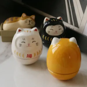 Japanese ceramic Daruma fortune cat figurines with hand-painted details and glossy finish