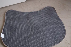 Detail of non-slip bottom texture and stitched edges on a cat-shaped door mat