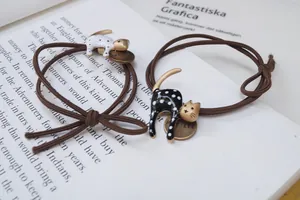 Set di due elastici per capelli a forma di gatto a pois su sfondo di libro d'epoca