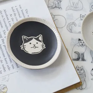 Japanese style ceramic cat saucer with hand-painted cat head and radial embossed texture