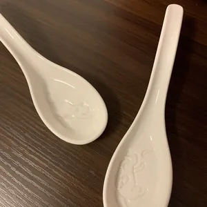 Japanese style white ceramic soup spoons with embossed silhouette cat pattern