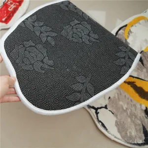 Close-up of non-slip dotted backing with floral patterns and neat white edge binding