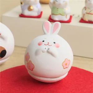 Japanese style hand-painted ceramic rabbit tumbler figurine with red felt base